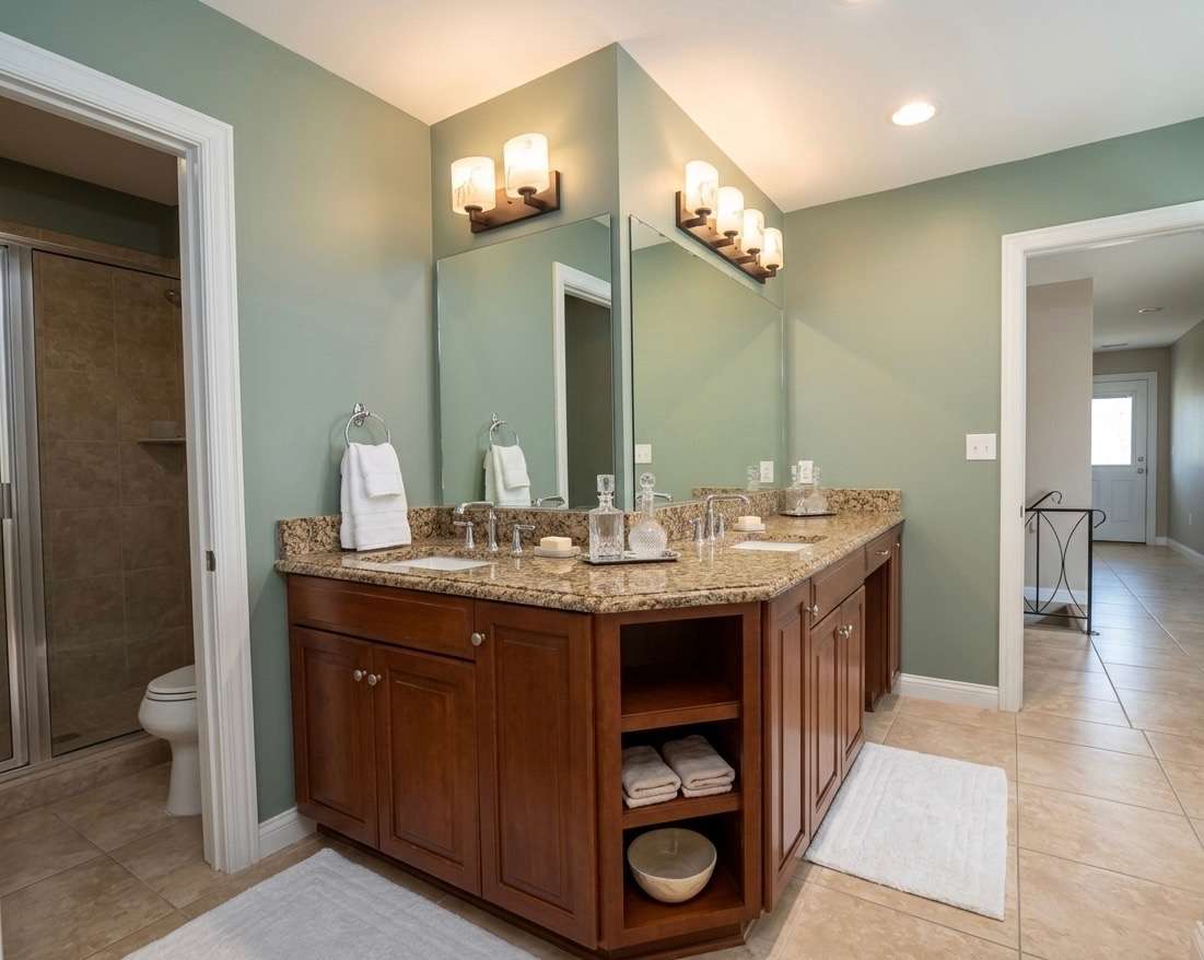 Remodeled master bathroom with custom tile and granite countertops